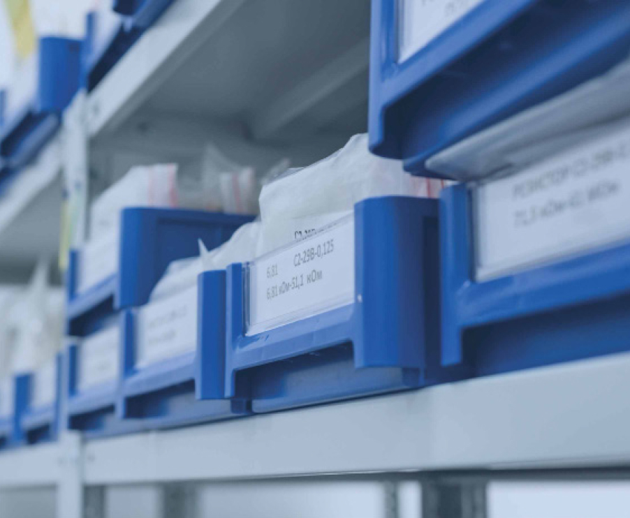 A shelf displaying blue bins, each labeled for easy organization and storage.